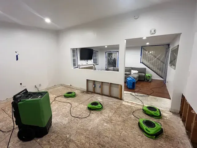 Air mover drying a flooded living room in Hawaiian Gardens